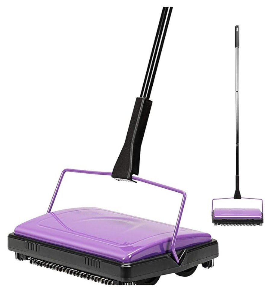 Purple manual carpet sweeper with a long handle, used by a student floor sweeper job in the classroom